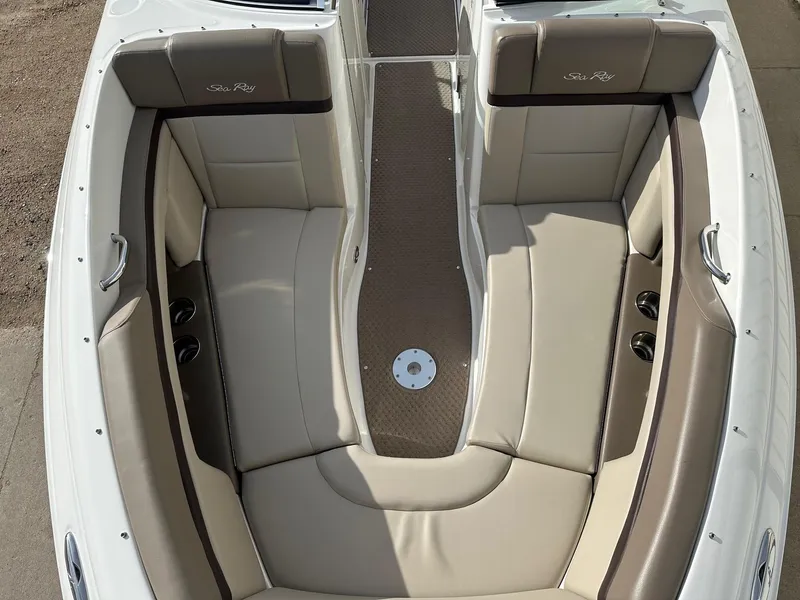 Slide: The Image of 2011 Sea Ray 250 SLX boat interior with beige seating and cup holders. - 9