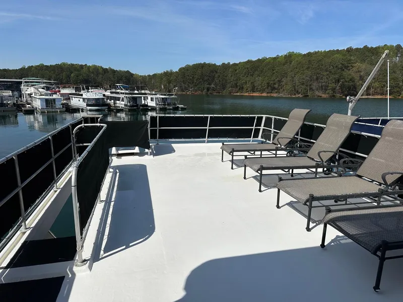 Slide: The Image of Upper deck of 2006 Lakeview 16x68 houseboat with lounge chairs, overlooking marina. - 16