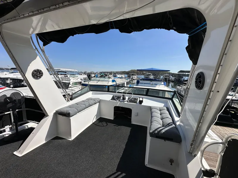Slide: The Image of Houseboat interior view, Lakeview 16x68, 2006 model, overlooking marina with clear blue sky. - 17