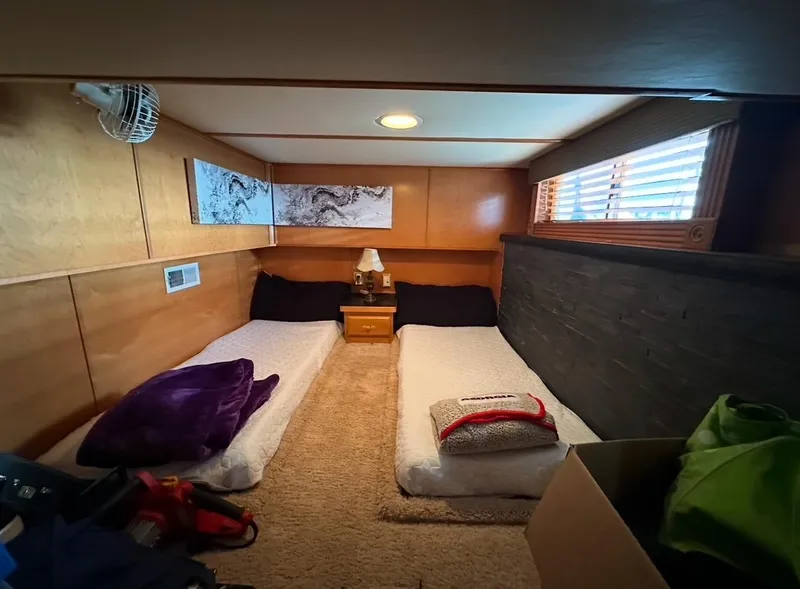 Slide: The Image of Cozy bedroom in 2006 Lakeview 16x68 houseboat with twin beds and wooden interior. - 7