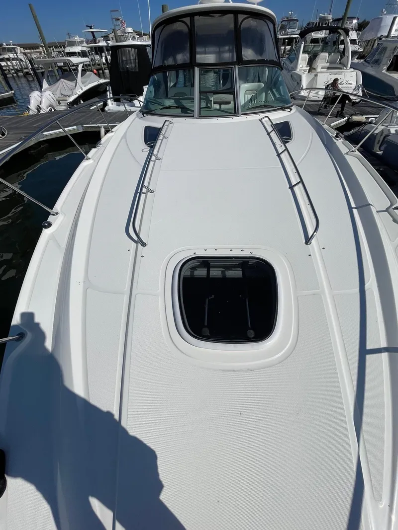 Slide: The Image of Cockpit of 2011 Sea Ray 370 Sundancer with steering wheel and control panel. - 11