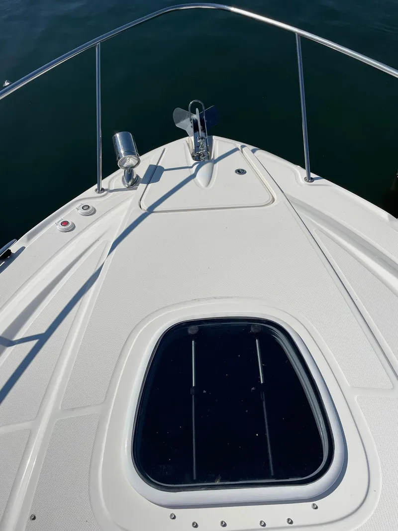 Slide: The Image of Luxury seating on 2011 Sea Ray 370 Sundancer boat, featuring white upholstery and speaker system. - 12