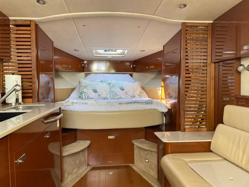 Slide: The Image of 2011 Sea Ray 370 Sundancer yacht with outdoor kitchenette and sink, docked at marina. - 13