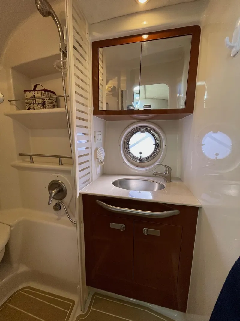Slide: The Image of Luxurious 2011 Sea Ray 370 Sundancer boat interior with white seating and wood flooring. - 15