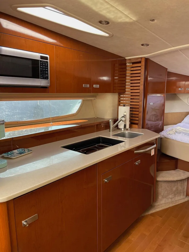 Slide: The Image of 2011 Sea Ray 370 Sundancer yacht on display at a marina with other boats. - 16