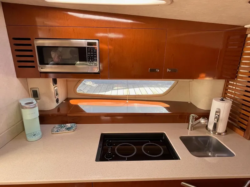 Slide: The Image of 2011 Sea Ray 370 Sundancer yacht docked, showcasing sleek design and polished railings. - 17