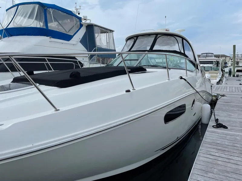 Slide: The Image of 2011 Sea Ray 370 Sundancer yacht on stands under clear blue sky. - 2