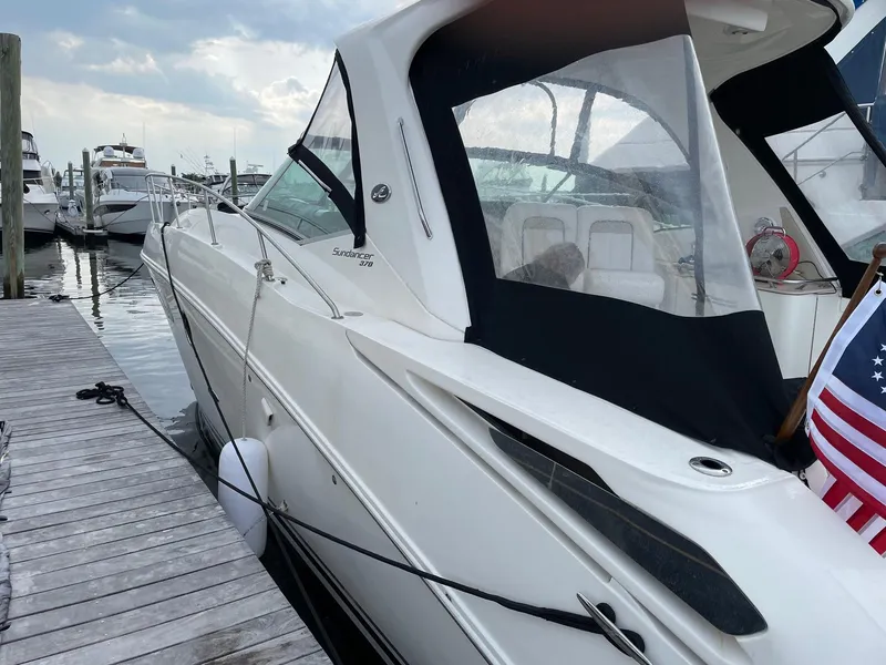 Slide: The Image of 2011 Sea Ray 370 Sundancer docked at marina with American flag. - 3