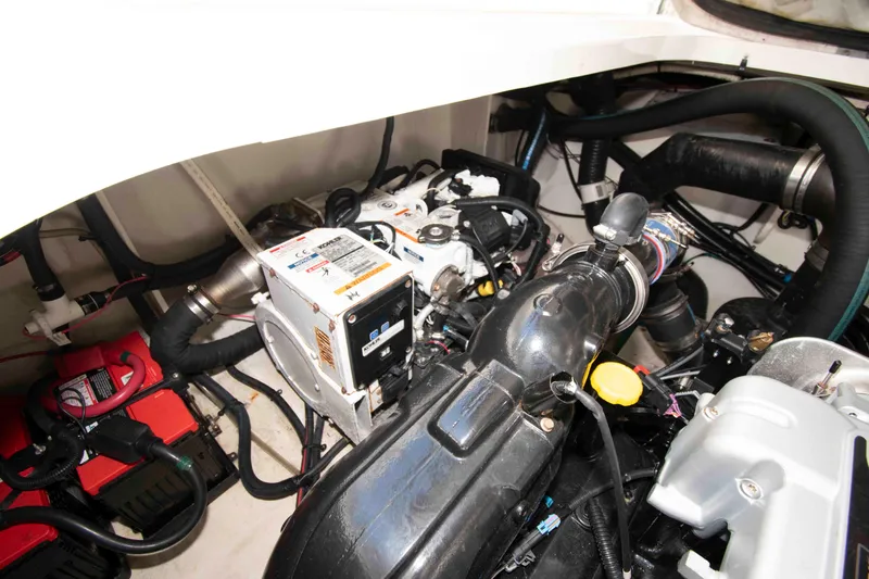 Slide: The Image of Engine compartment of 2011 Sea Ray 370 Sundancer, showcasing mechanical components and wiring. - 31