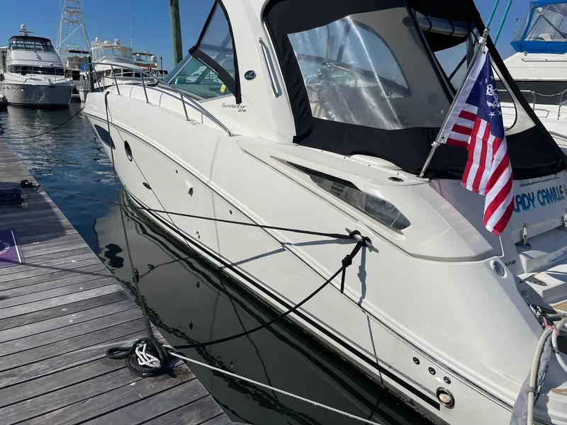 Slide: The Image of 2011 Sea Ray 370 Sundancer yacht docked under clear blue sky. - 4
