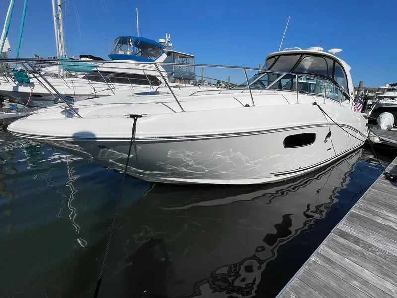 Slide: The Image of 2011 Sea Ray 370 Sundancer docked at marina under clear blue sky. - 5