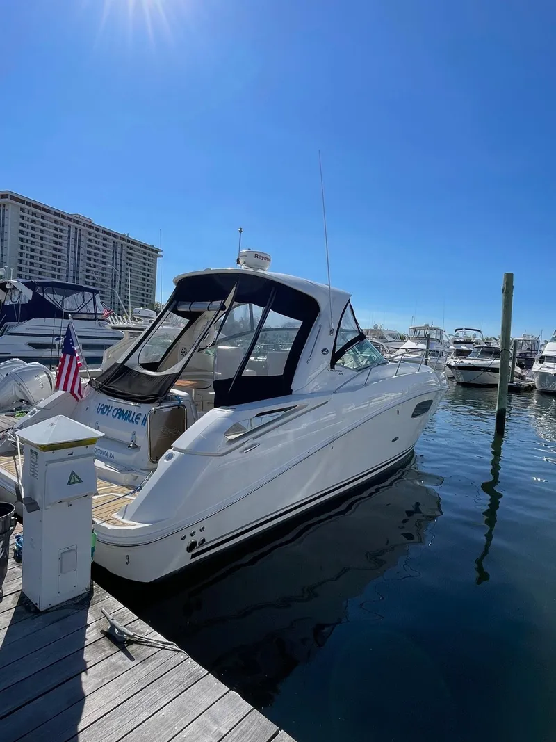 Slide: The Image of Luxurious 2011 Sea Ray 370 Sundancer boat interior with white seating and sleek design. - 7