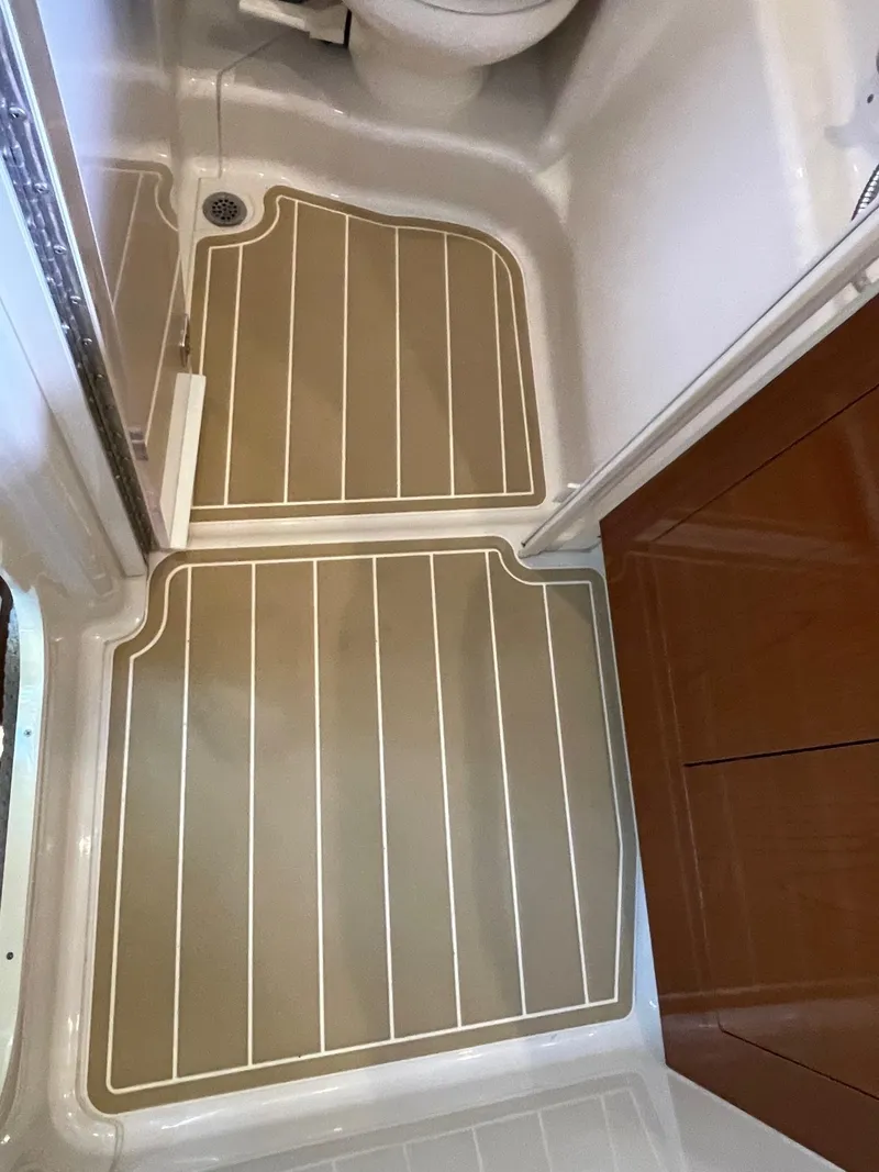 Slide: The Image of Cockpit of 2011 Sea Ray 370 Sundancer with steering wheel and control panel. - 8