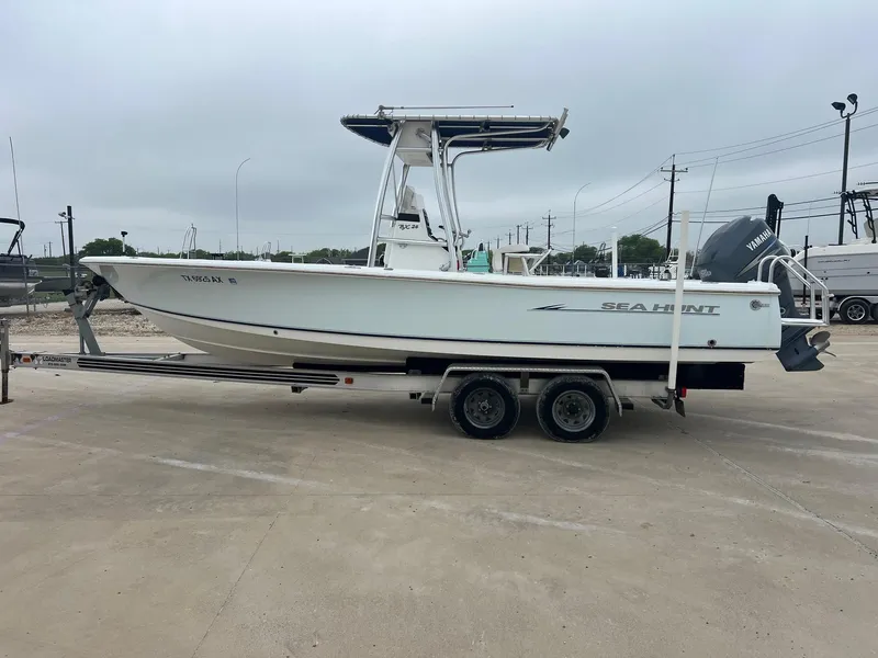 Slide: The Image of 2009 Sea Hunt BX24 boat on trailer, side view, overcast sky. - 1