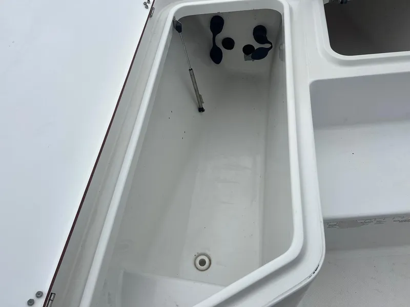 Slide: The Image of Open storage compartment on a 2009 Sea Hunt BX24 boat. - 17