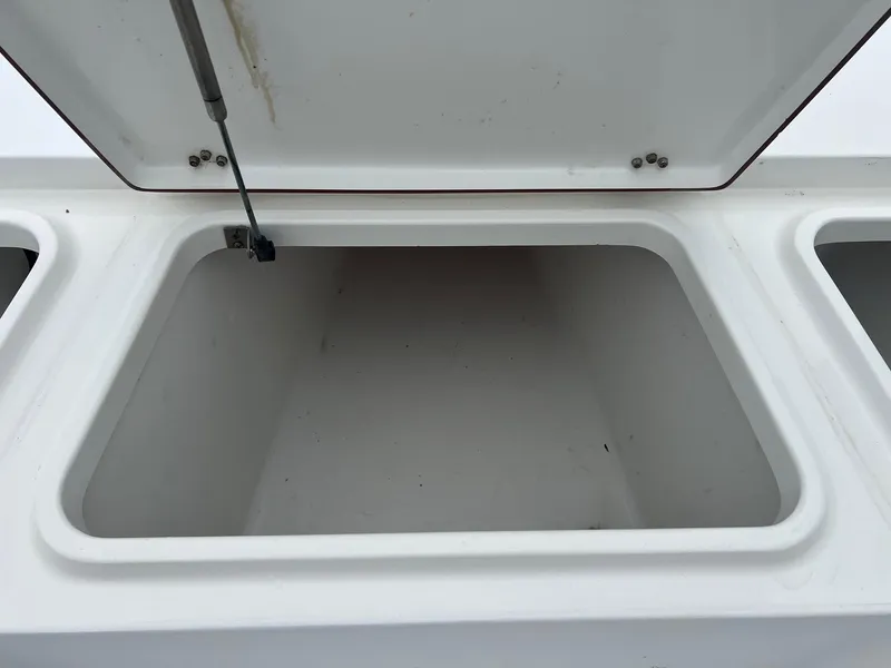 Slide: The Image of Open storage compartment on a 2009 Sea Hunt BX24 boat. - 18