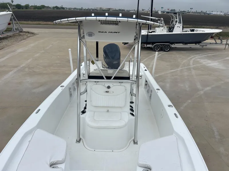 Slide: The Image of 2009 Sea Hunt BX24 boat with T-top, parked on concrete lot. - 20