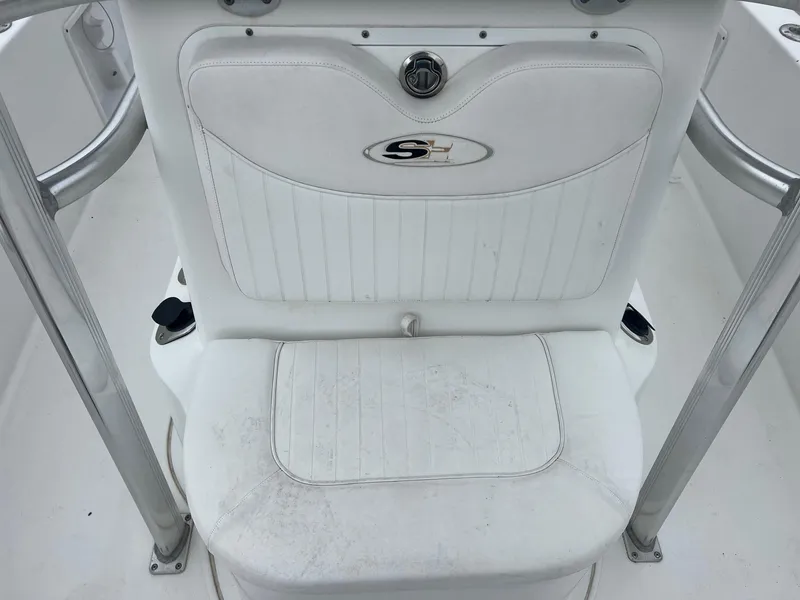 Slide: The Image of White seat on a 2009 Sea Hunt BX24 boat, featuring stainless steel supports. - 21