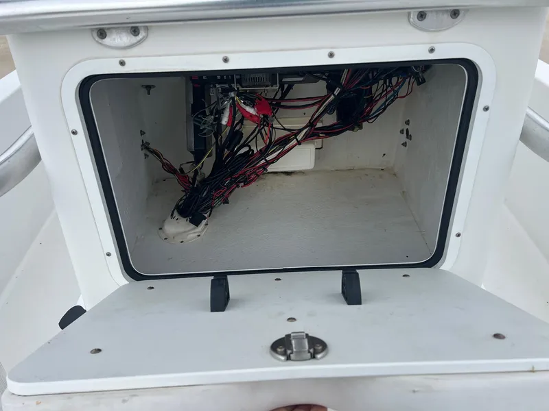 Slide: The Image of Open compartment of 2009 Sea Hunt BX24 boat showing internal wiring. - 23