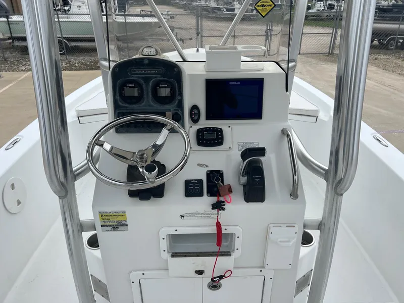 Slide: The Image of 2009 Sea Hunt BX24 boat console with steering wheel, controls, and navigation display. - 24