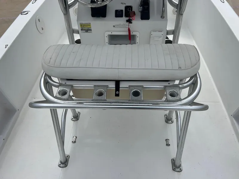 Slide: The Image of 2009 Sea Hunt BX24 boat interior with white cushioned bench and metal frame. - 27