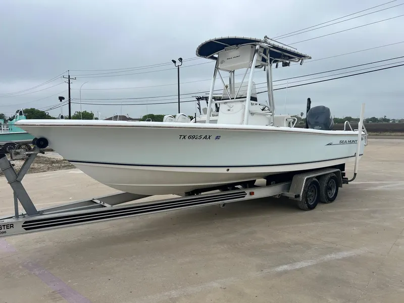 Slide: The Image of 2009 Sea Hunt BX24 boat on trailer in parking lot, side view. - 3