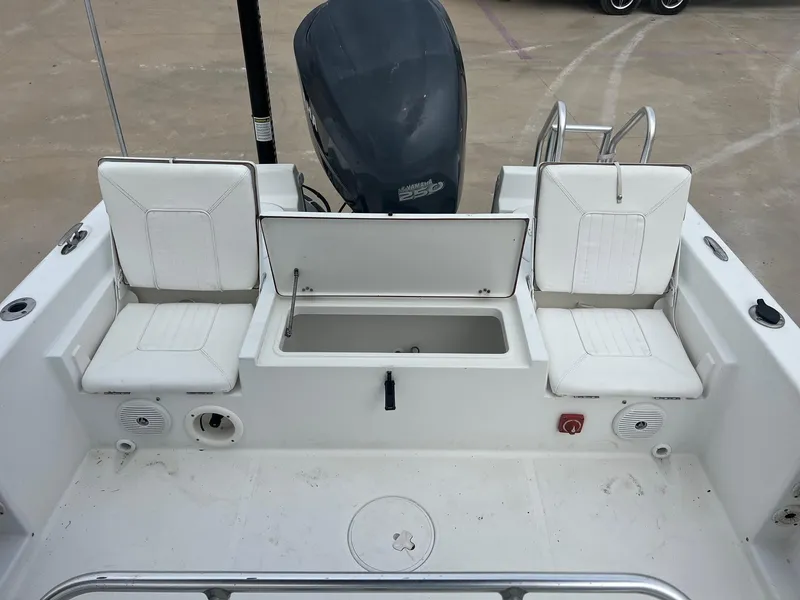 Slide: The Image of 2009 Sea Hunt BX24 boat interior with seating and storage compartment. - 30