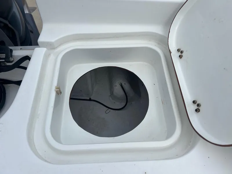 Slide: The Image of Open hatch on 2009 Sea Hunt BX24 boat, showing interior compartment. - 32