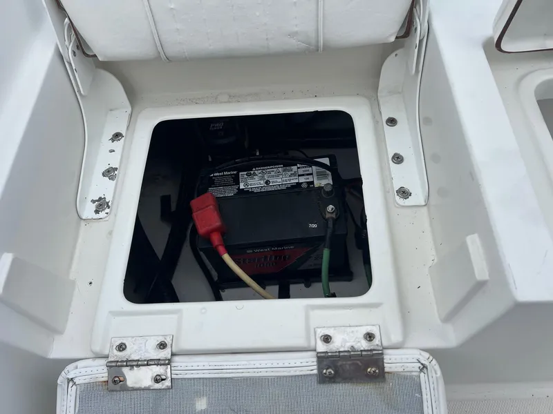 Slide: The Image of Battery compartment of a 2009 Sea Hunt BX24 boat, showing wiring and connections. - 34