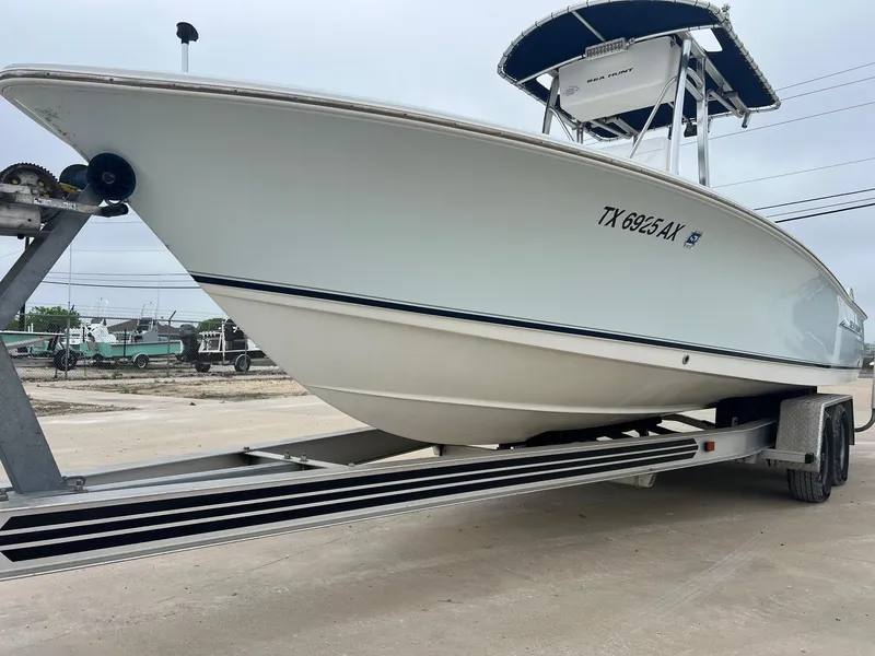 Slide: The Image of 2009 Sea Hunt BX24 boat on trailer, side view, with registration number TX 6925 AX. - 5