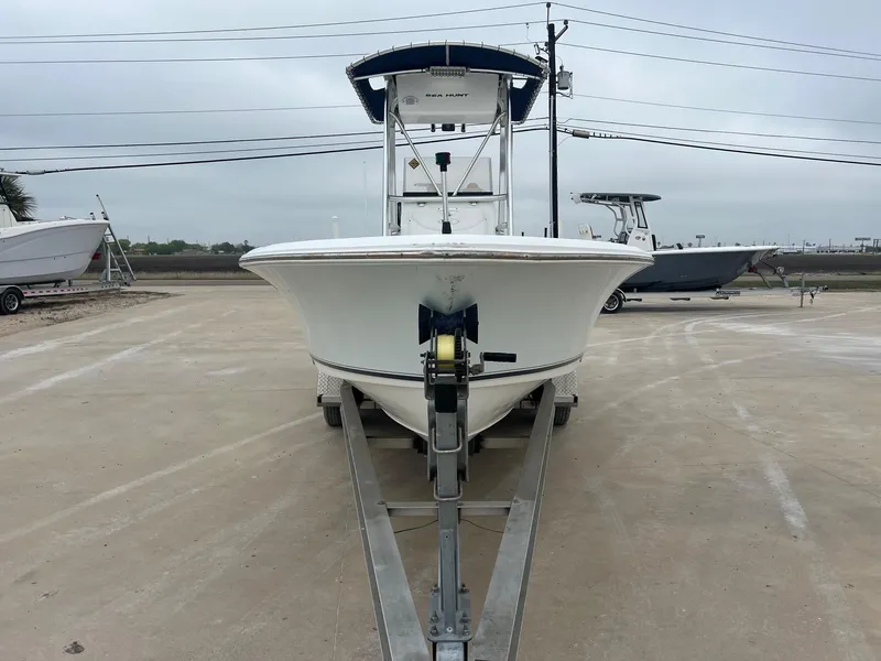 Slide: The Image of 2009 Sea Hunt BX24 boat on trailer in parking lot, overcast sky. - 6