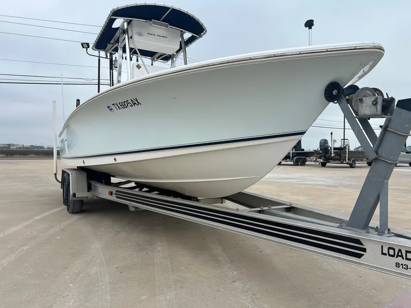 Slide: The Image of 2009 Sea Hunt BX24 boat on trailer, parked in a lot, side view. - 7