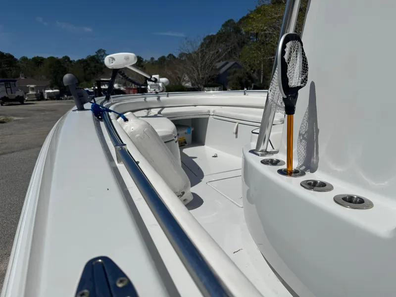 Slide: The Image of 2015 Contender 24 Sport boat deck with fishing gear and rod holders. - 13