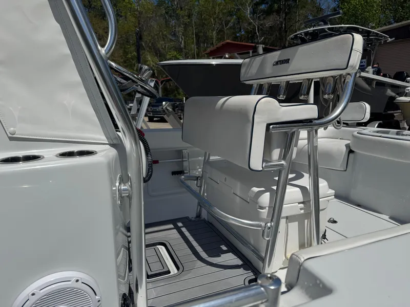 Slide: The Image of 2015 Contender 24 Sport boat interior with white seating and steering console. - 15