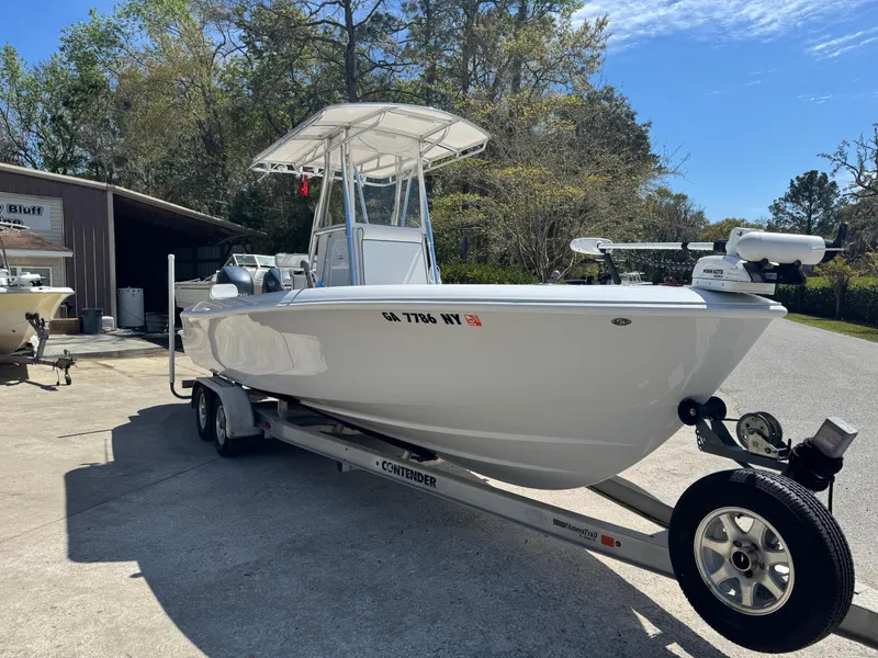 Slide: The Image of 2015 Contender 24 Sport boat on trailer, parked outdoors under clear sky. - 2