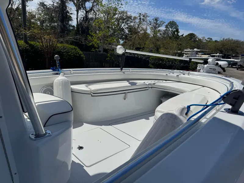 Slide: The Image of 2015 Contender 24 Sport boat with spacious seating and sleek design, docked outdoors. - 20