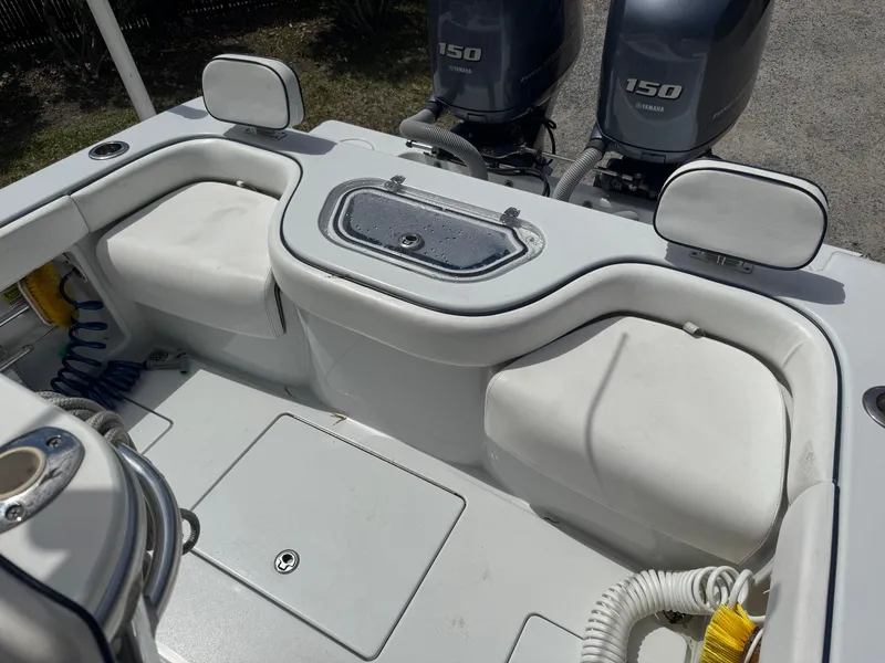 Slide: The Image of 2015 Contender 24 Sport boat interior with dual 150 engines, featuring seating and storage. - 25