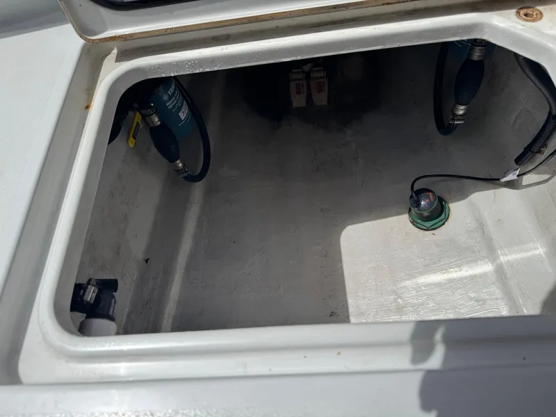 Slide: The Image of Open storage compartment in a 2015 Contender 24 Sport boat. - 26