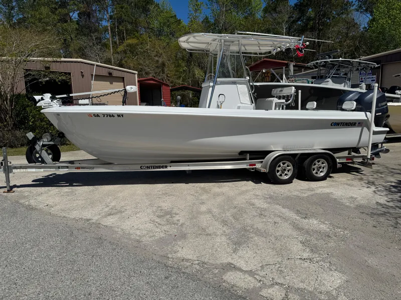 Slide: The Image of 2015 Contender 24 Sport boat on trailer, parked outdoors. - 3