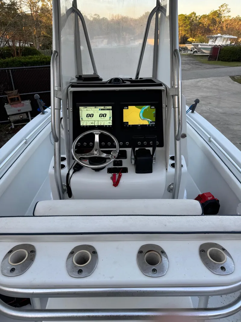 Slide: The Image of 2015 Contender 24 Sport boat dashboard with navigation screens and steering wheel. - 6