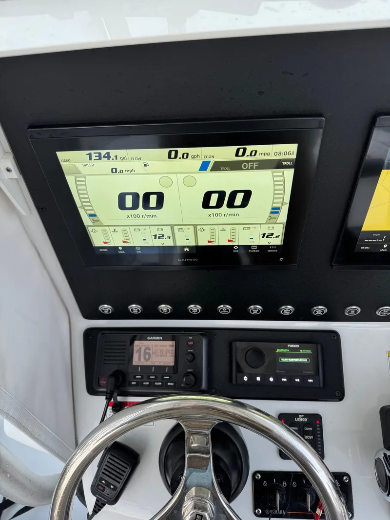 Slide: The Image of 2015 Contender 24 Sport dashboard with digital display and steering wheel. - 8