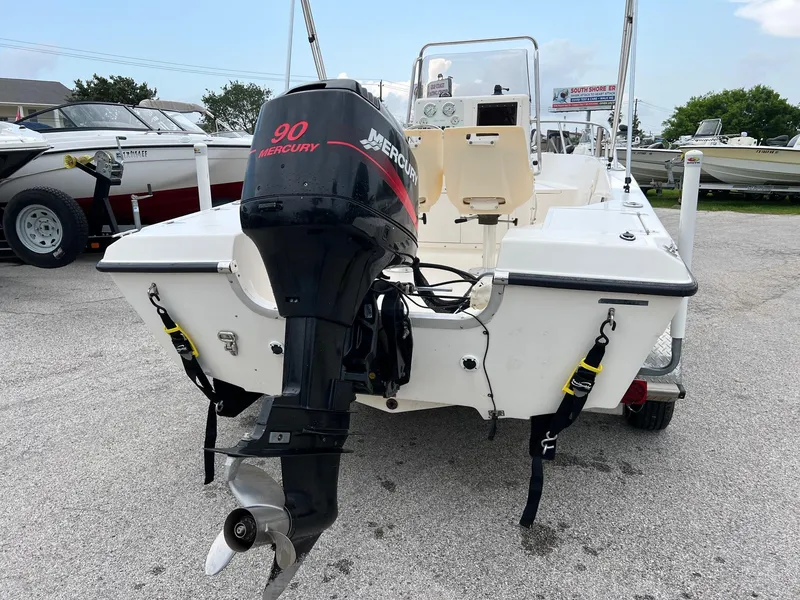 Slide: The Image of 2000 Sea Pro 180 Center Console boat with 90 Mercury outboard motor, parked on gravel. - 12