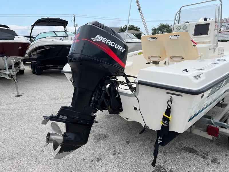 Slide: The Image of 2000 Sea Pro 180 Center Console boat with Mercury outboard motor in a marina setting. - 13