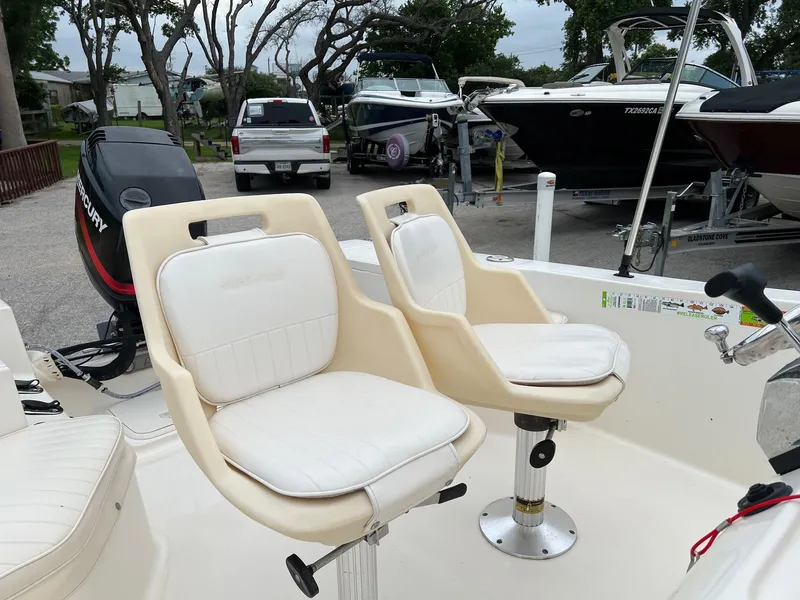 Slide: The Image of 2000 Sea Pro 180 Center Console boat with white swivel seats and Mercury outboard motor. - 3