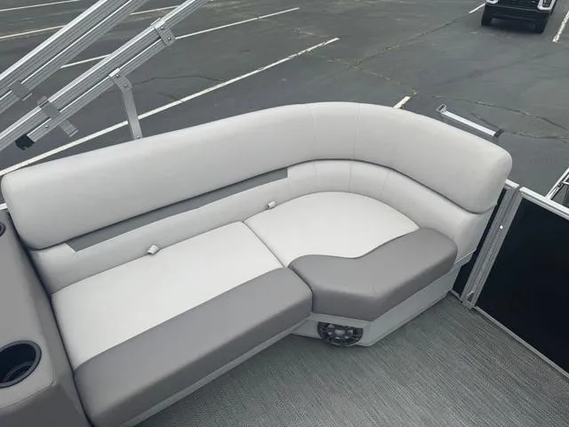 Slide: The Image of Luxurious seating on 2023 Godfrey Sweetwater 2286 SBX Tritoon boat, featuring plush gray upholstery. - 11
