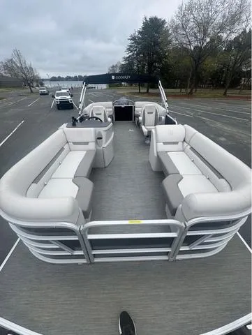 Slide: The Image of 2023 Godfrey Sweetwater 2286 SBX Tritoon with Yamaha 150, spacious seating, parked outdoors. - 2