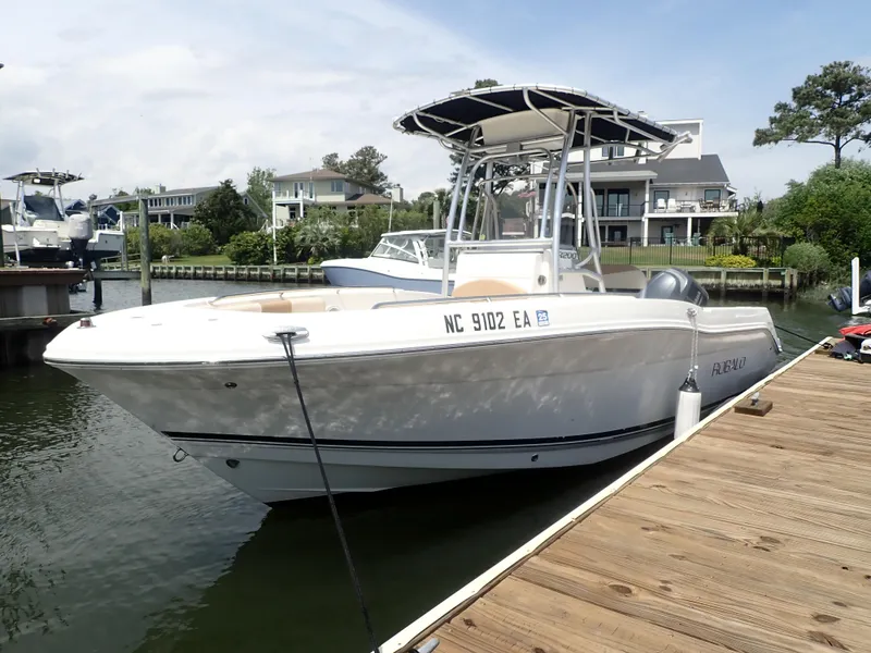 Slide: The Image of 2014 Robalo R200 Center Console boat docked by waterfront homes. - 10