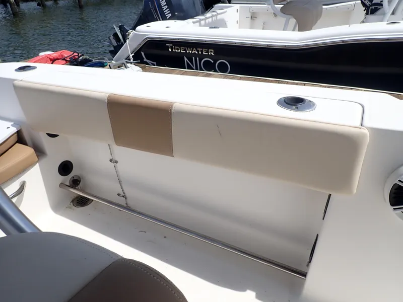 Slide: The Image of 2014 Robalo R200 Center Console boat interior with seating and rod holders. - 11