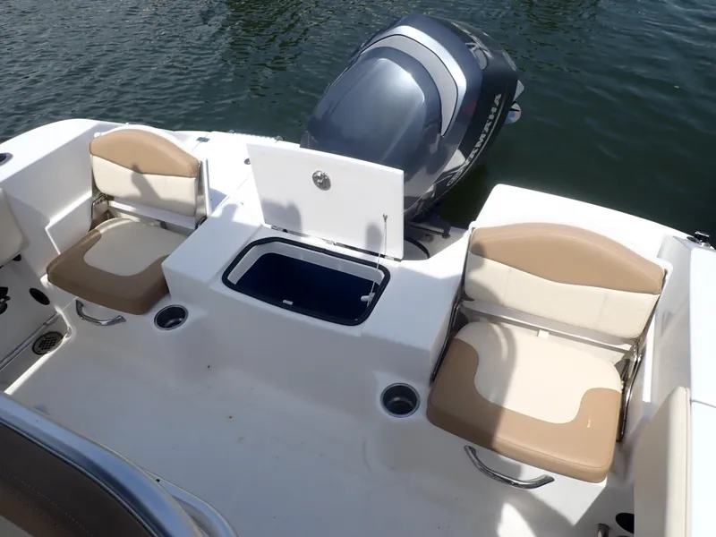 Slide: The Image of 2014 Robalo R200 Center Console boat with seating and outboard motor on water. - 13