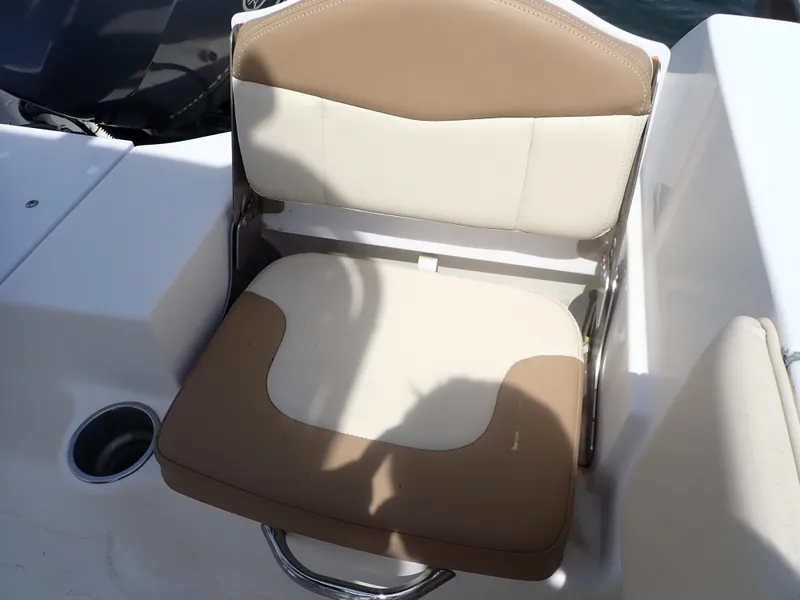 Slide: The Image of 2014 Robalo R200 Center Console boat seat with beige and white upholstery. - 15